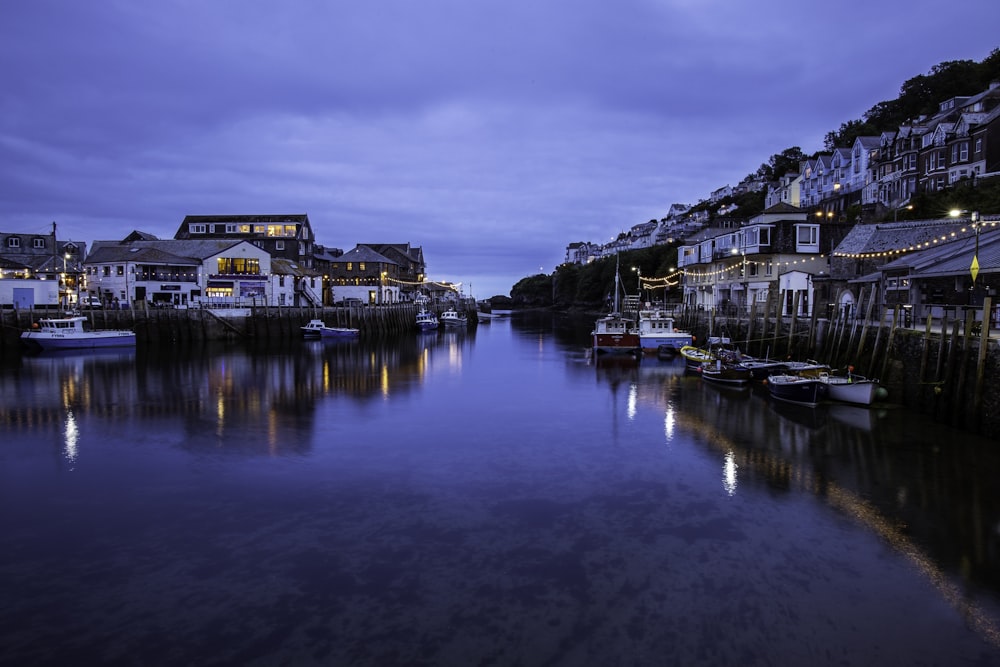 a harbor filled with lots of boats under a cloudy sky