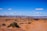 A group of people engaged in a guided tour in a desert landscape.