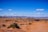 A group of people engaged in a guided tour in a desert landscape.