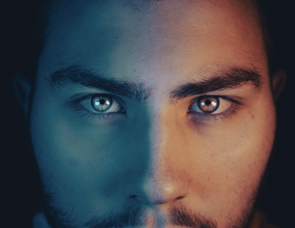a close up of a man with blue eyes