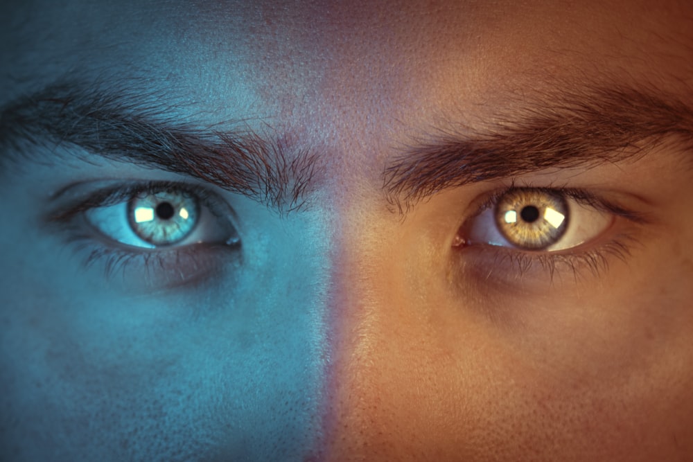 a man's face with two different colored eyes