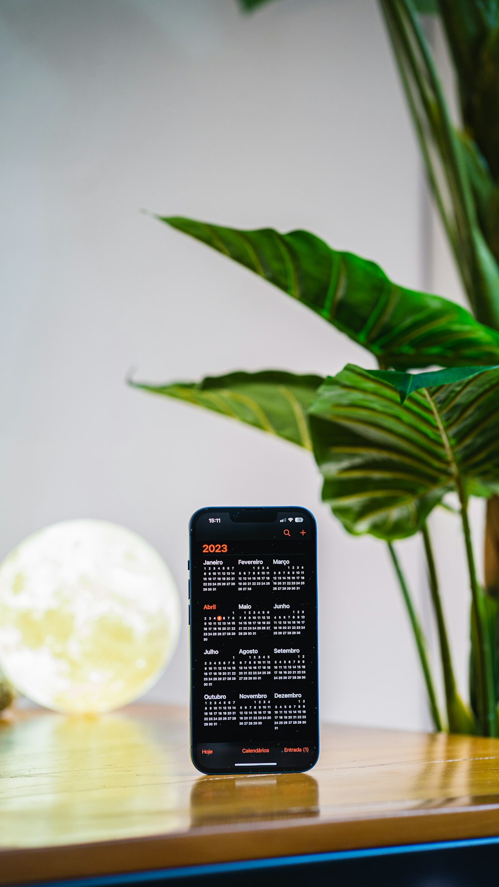 a black clock sitting on top of a wooden table