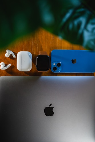 an apple laptop computer sitting on top of a wooden table