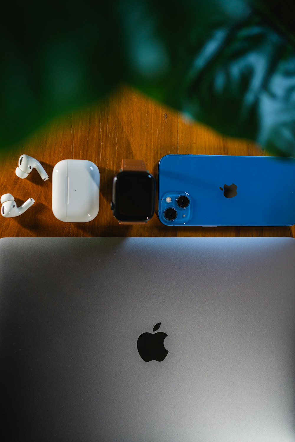 an apple laptop computer sitting on top of a wooden table