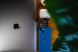 an apple laptop computer sitting on top of a wooden table