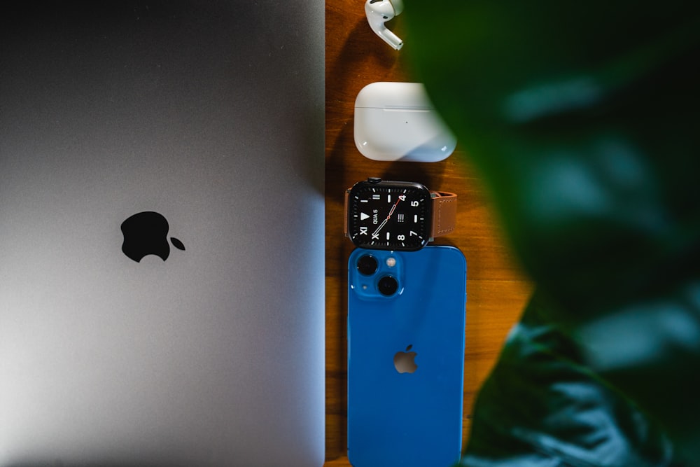 an apple laptop computer sitting on top of a wooden table