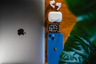 an apple watch, earbuds, and an ipod on a table