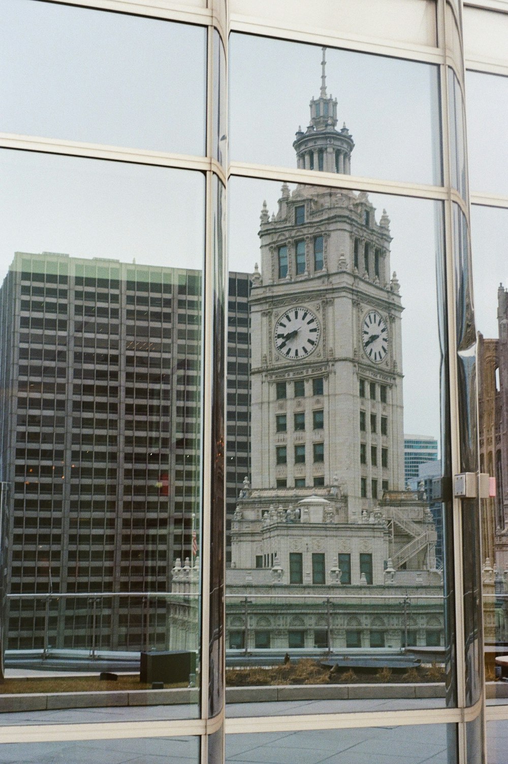 a reflection of a clock tower in a window