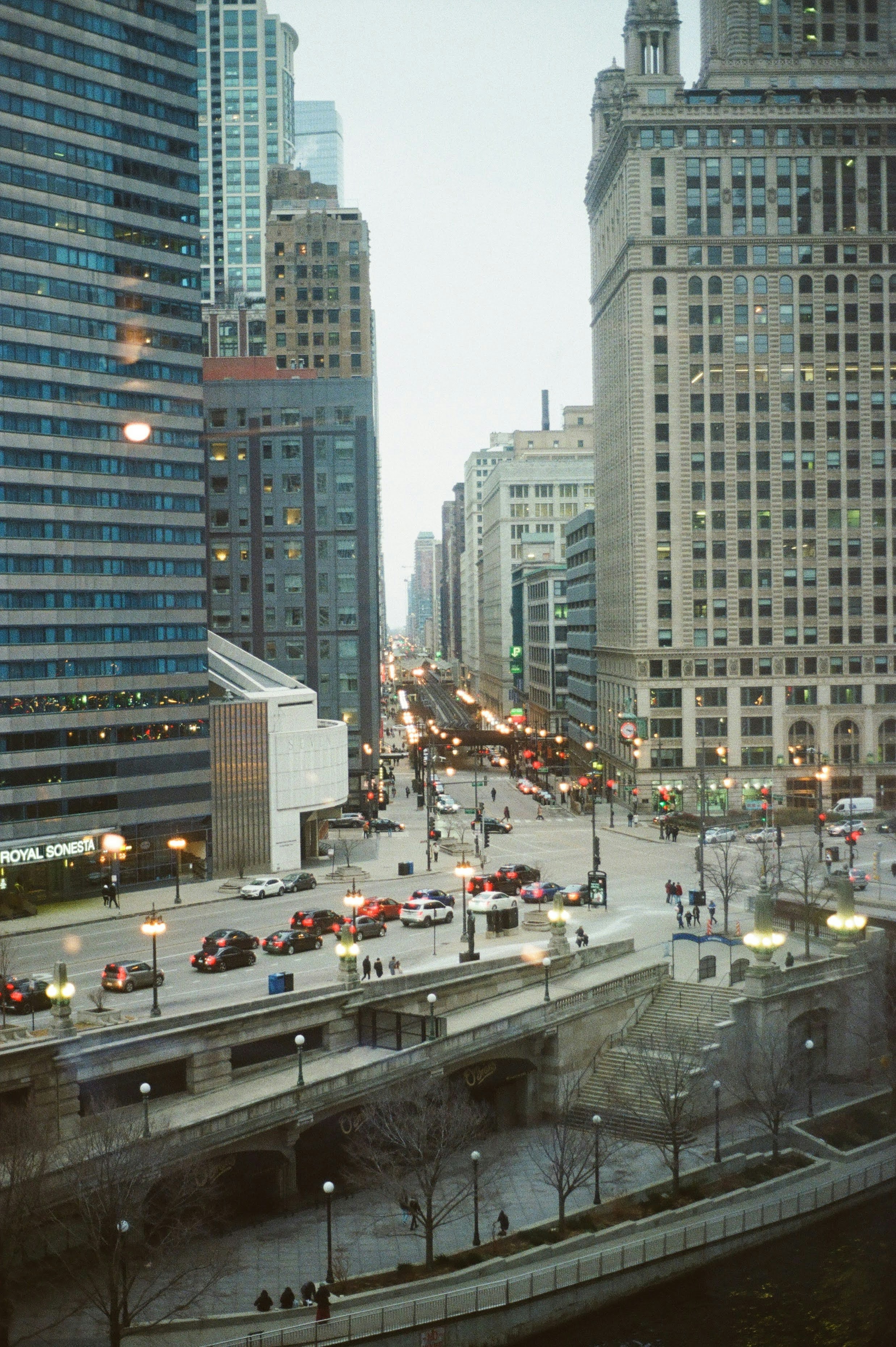 A city street filled with lots of traffic next to tall buildings photo ...