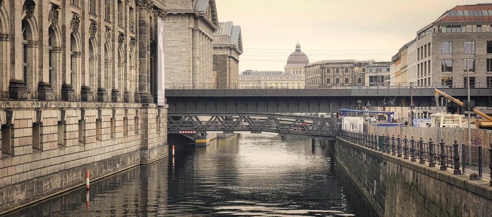 a river running through a city next to tall buildings