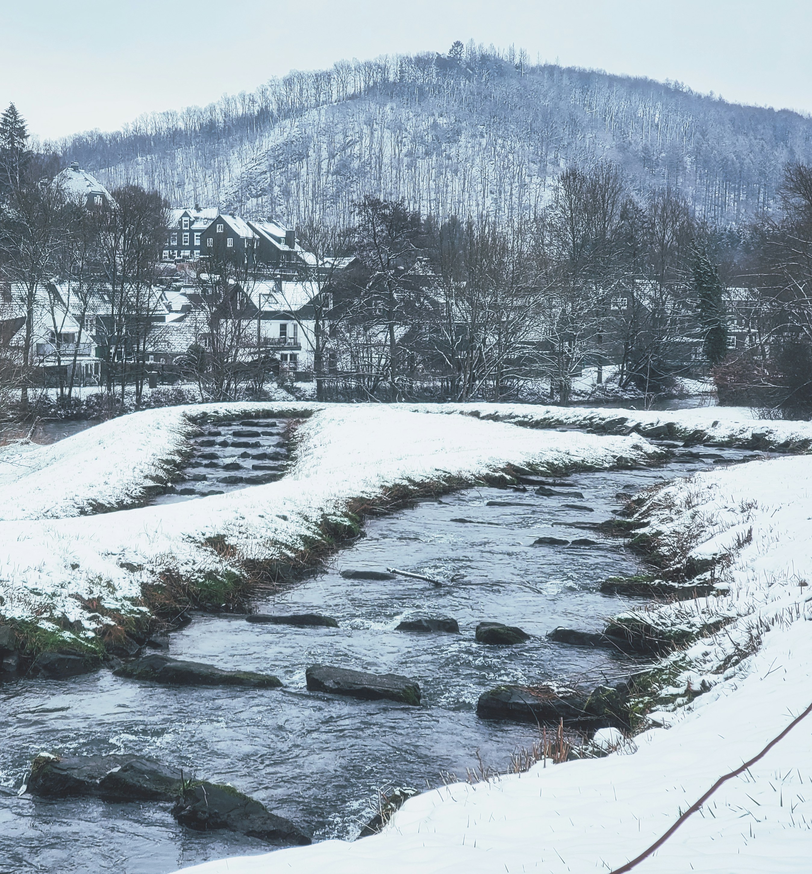 a river running through a snow covered forest