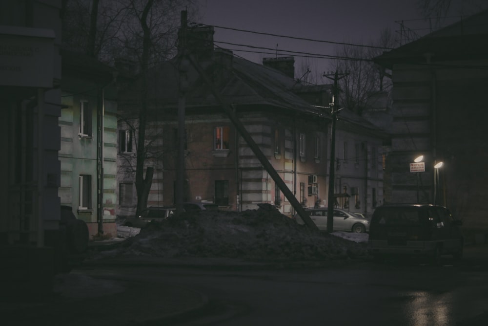 a truck is parked in front of a building at night