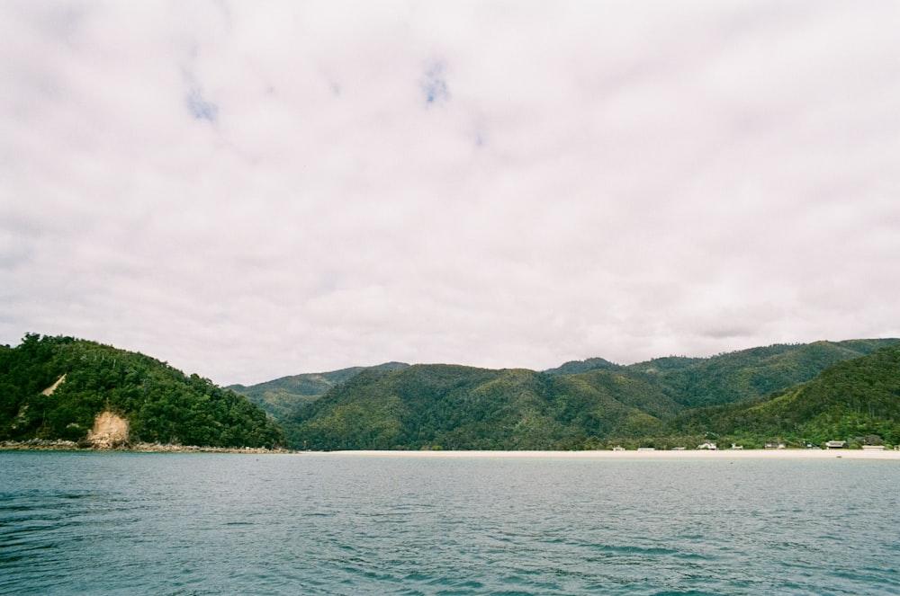 a body of water with a mountain range in the background