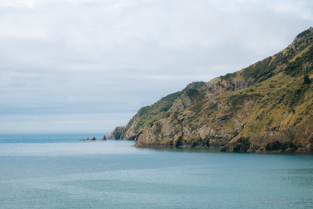 a body of water with a mountain in the background