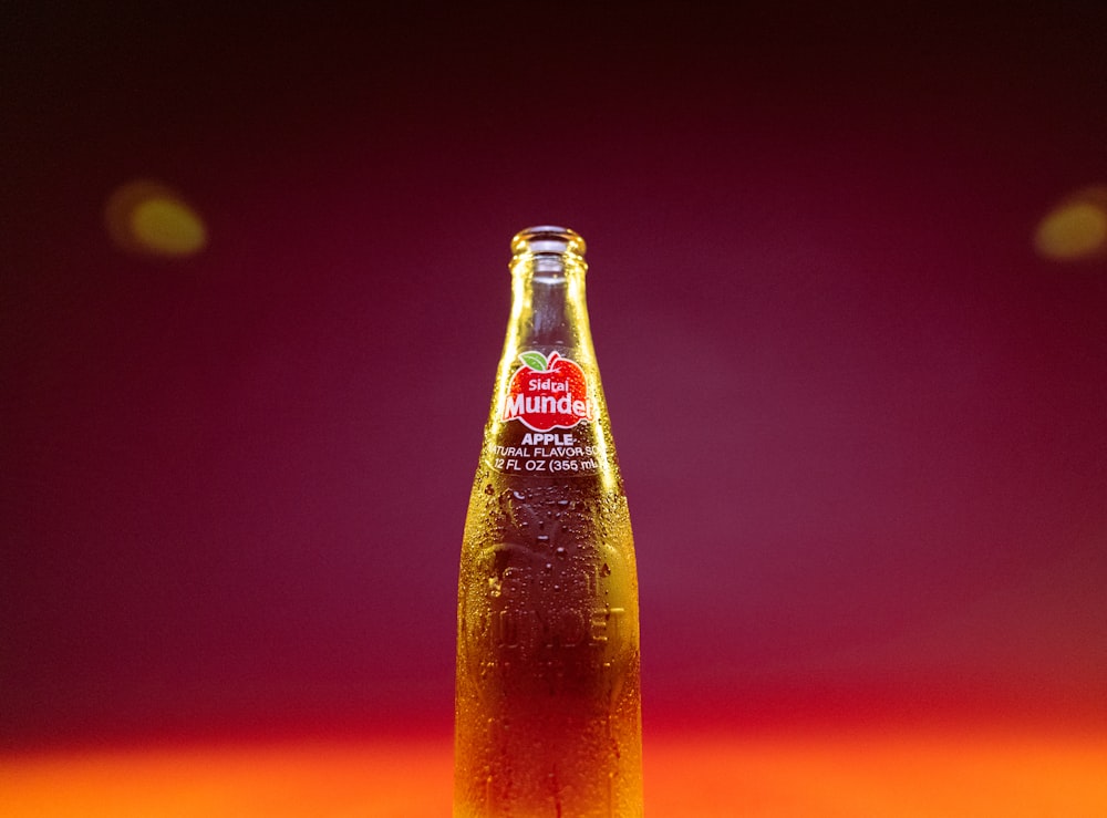 a bottle of apple cider sitting on a table