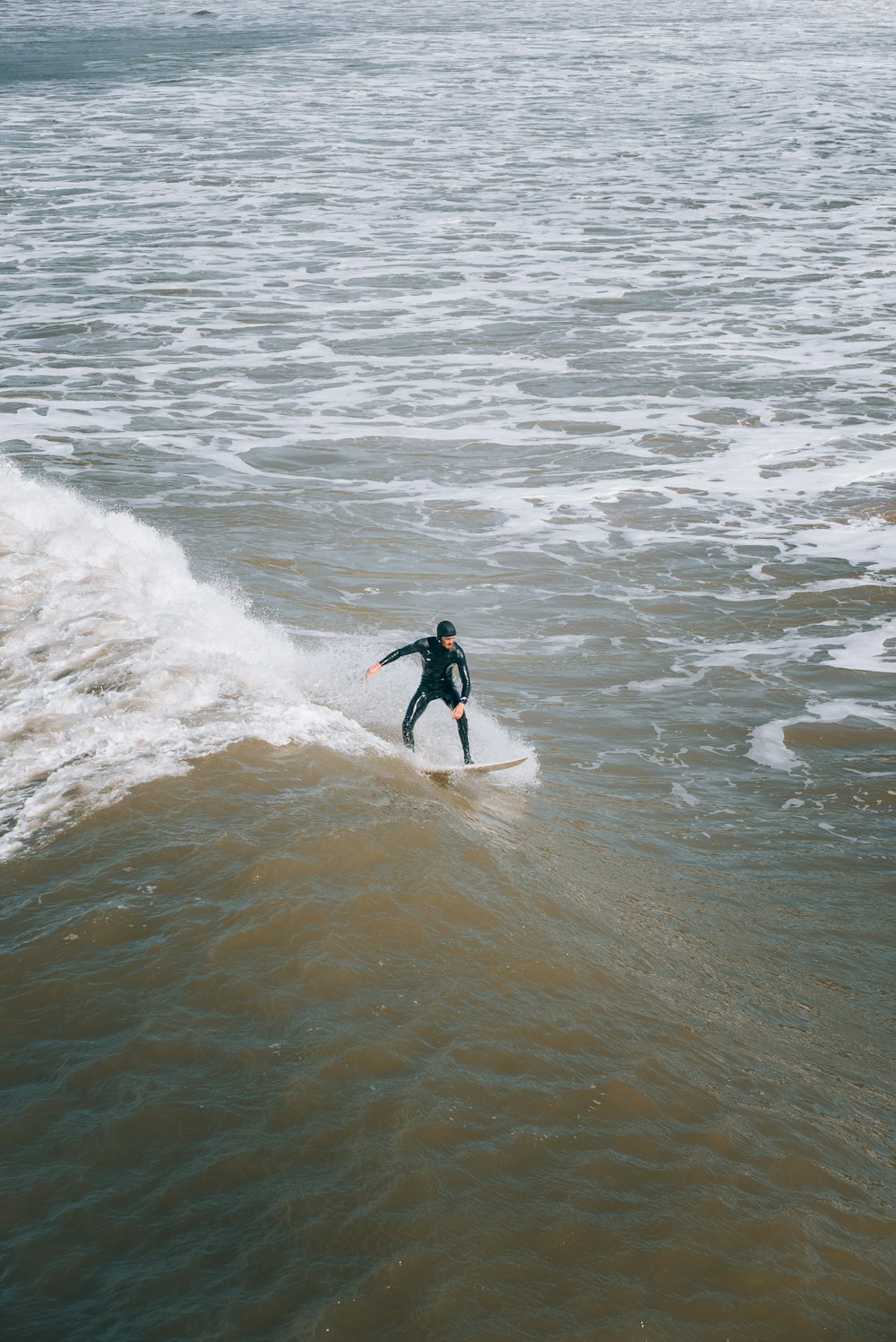 a man riding a wave on top of a surfboard