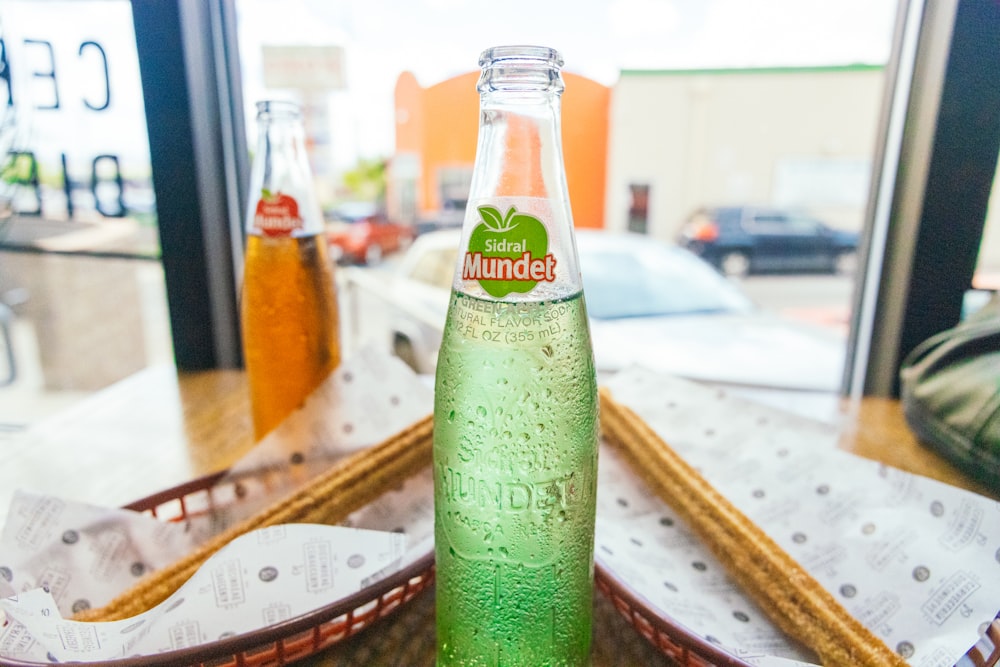a close up of a bottle of soda on a table