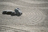 A calm zen garden with raked gravel and smooth stones, embodying balance and focus.