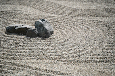 A calm zen garden with raked gravel and smooth stones, embodying balance and focus.