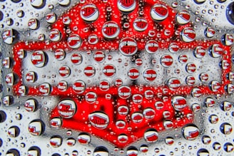a close up of water droplets on a red object