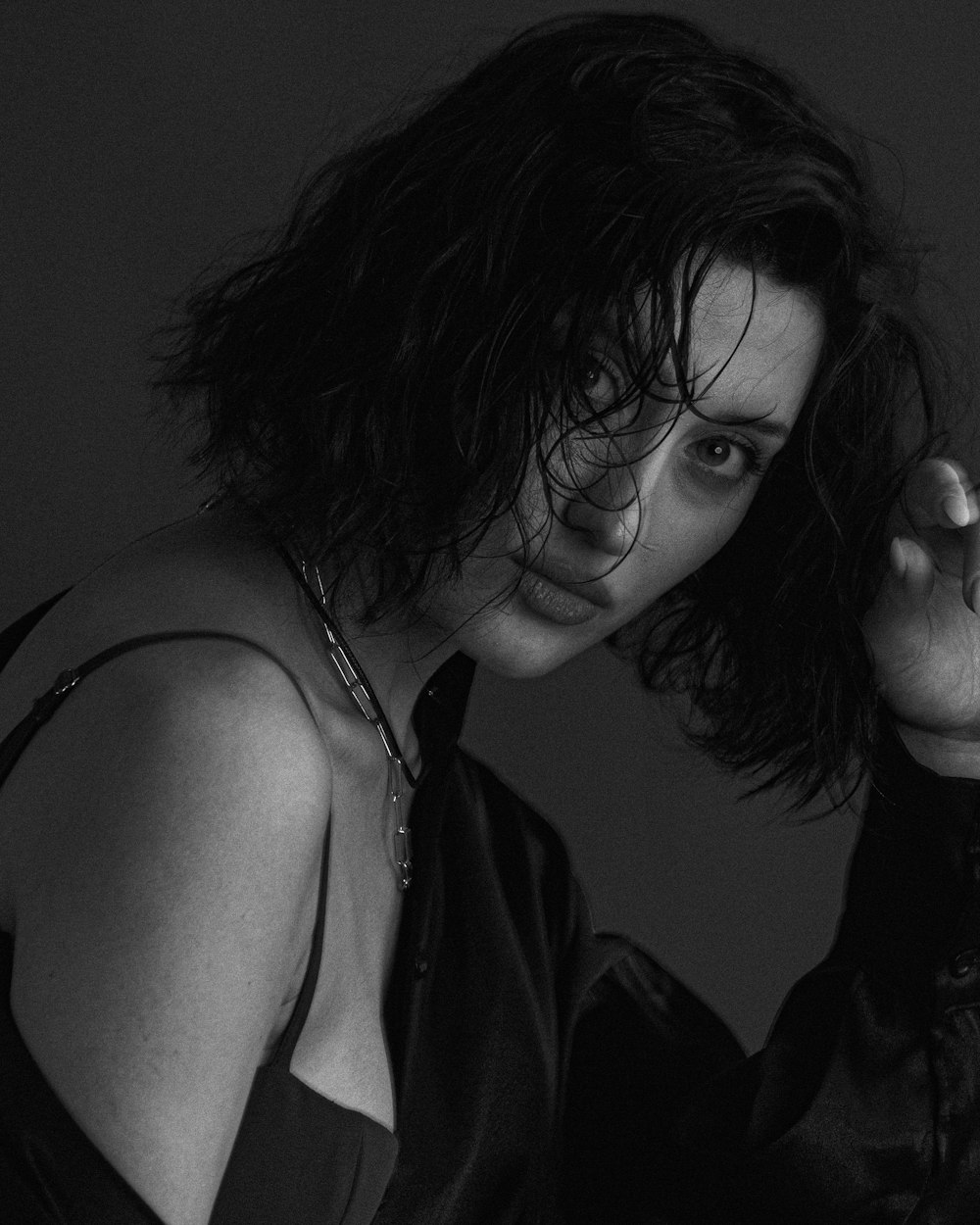 a black and white photo of a woman with wet hair