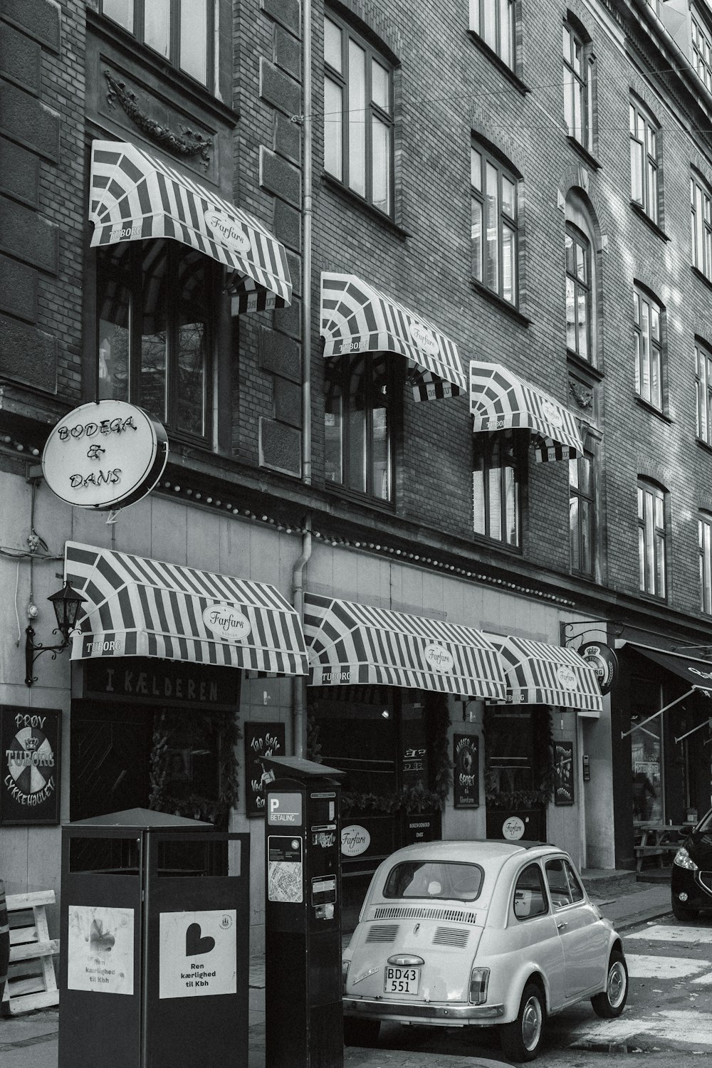 a car parked in front of a building with awnings