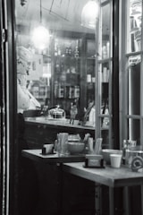 A hotel staff member scanning products at a cozy hotel bazar counter.
