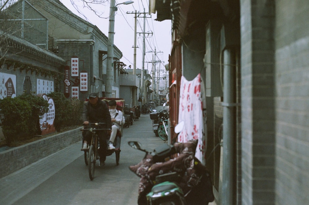 a couple of people riding bikes down a street