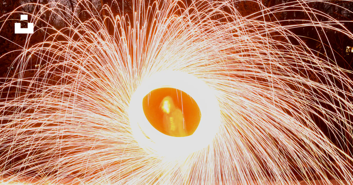 Firework Object Show A large orange object is in the middle of a firework display photo ...