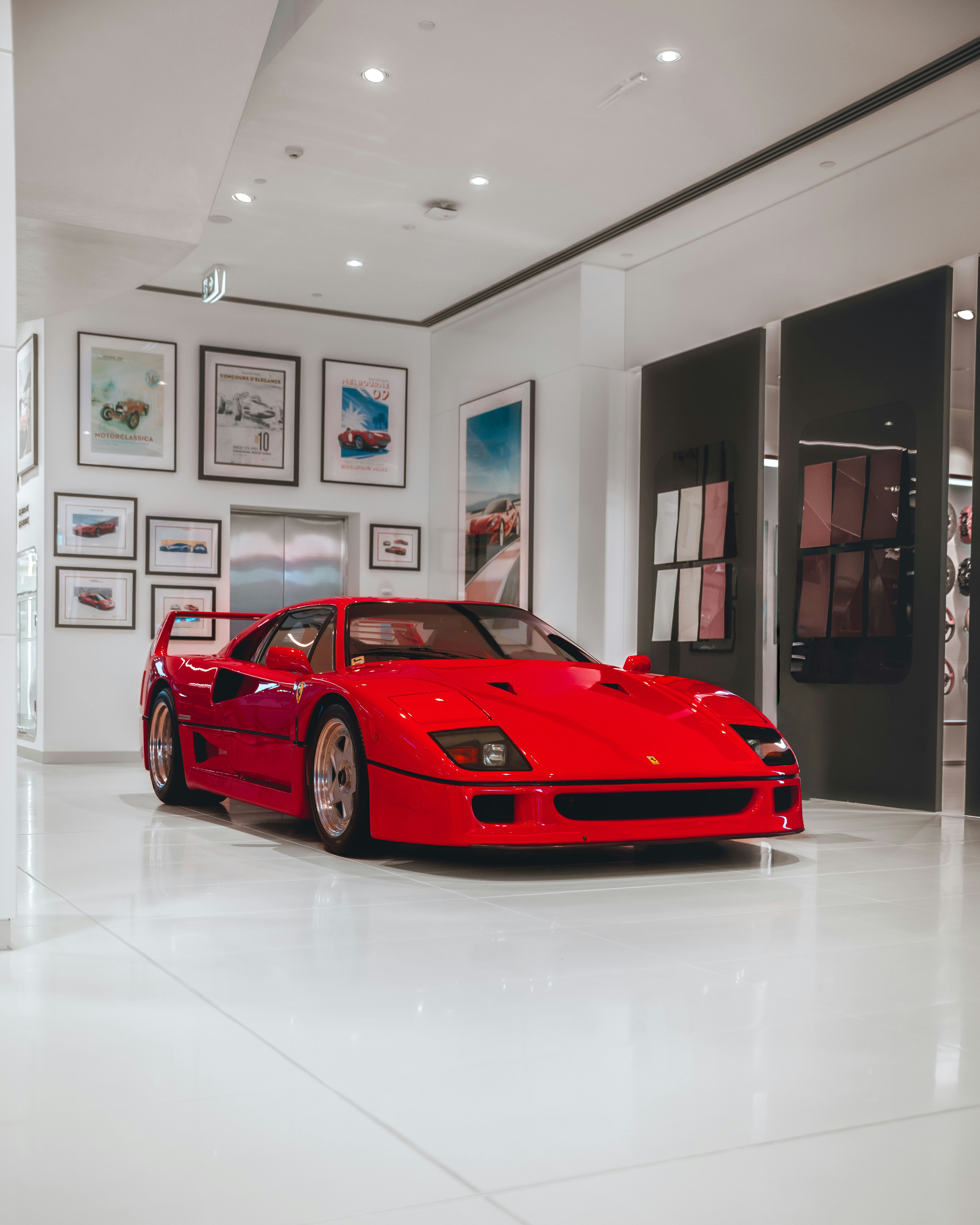 a red sports car parked in a white room