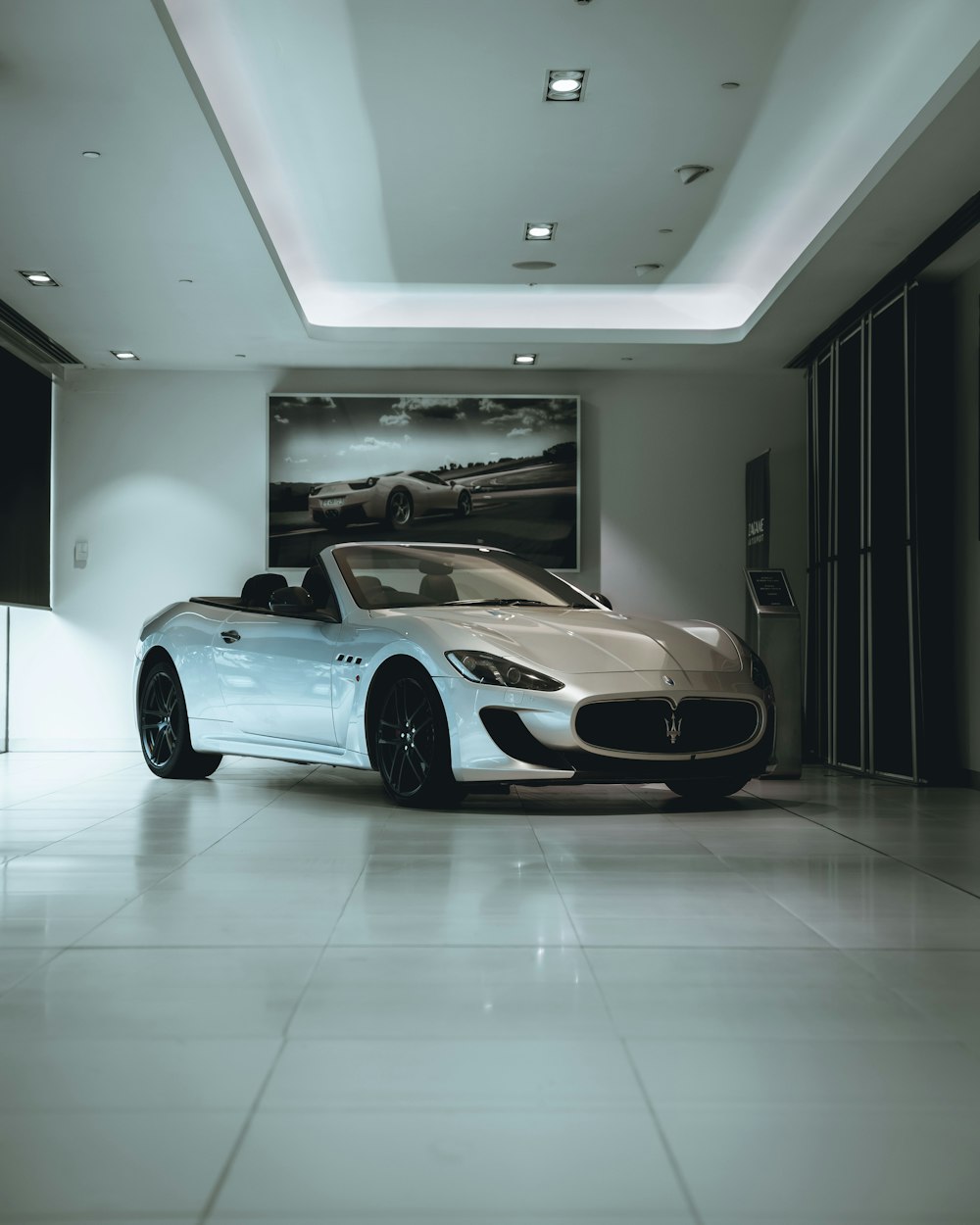 a white masera parked in a large room
