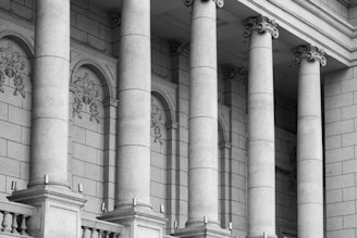 a black and white photo of a building with columns