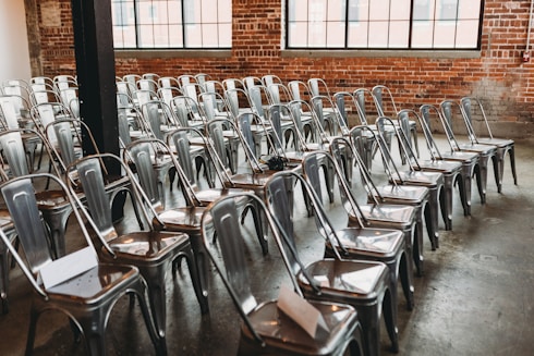 a room filled with lots of metal chairs