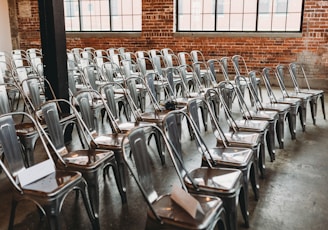 a room filled with lots of metal chairs