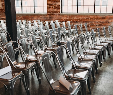 a room filled with lots of metal chairs