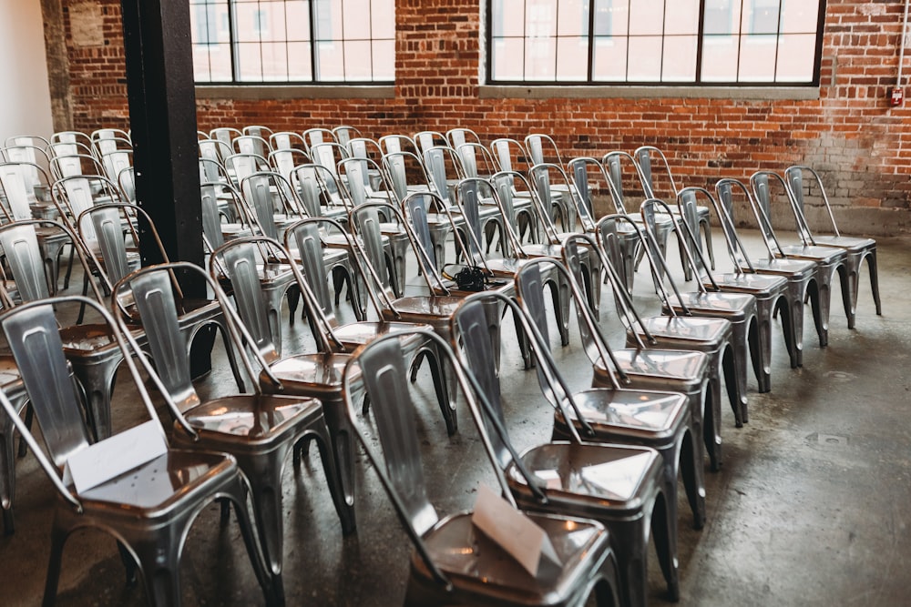 a room filled with lots of metal chairs