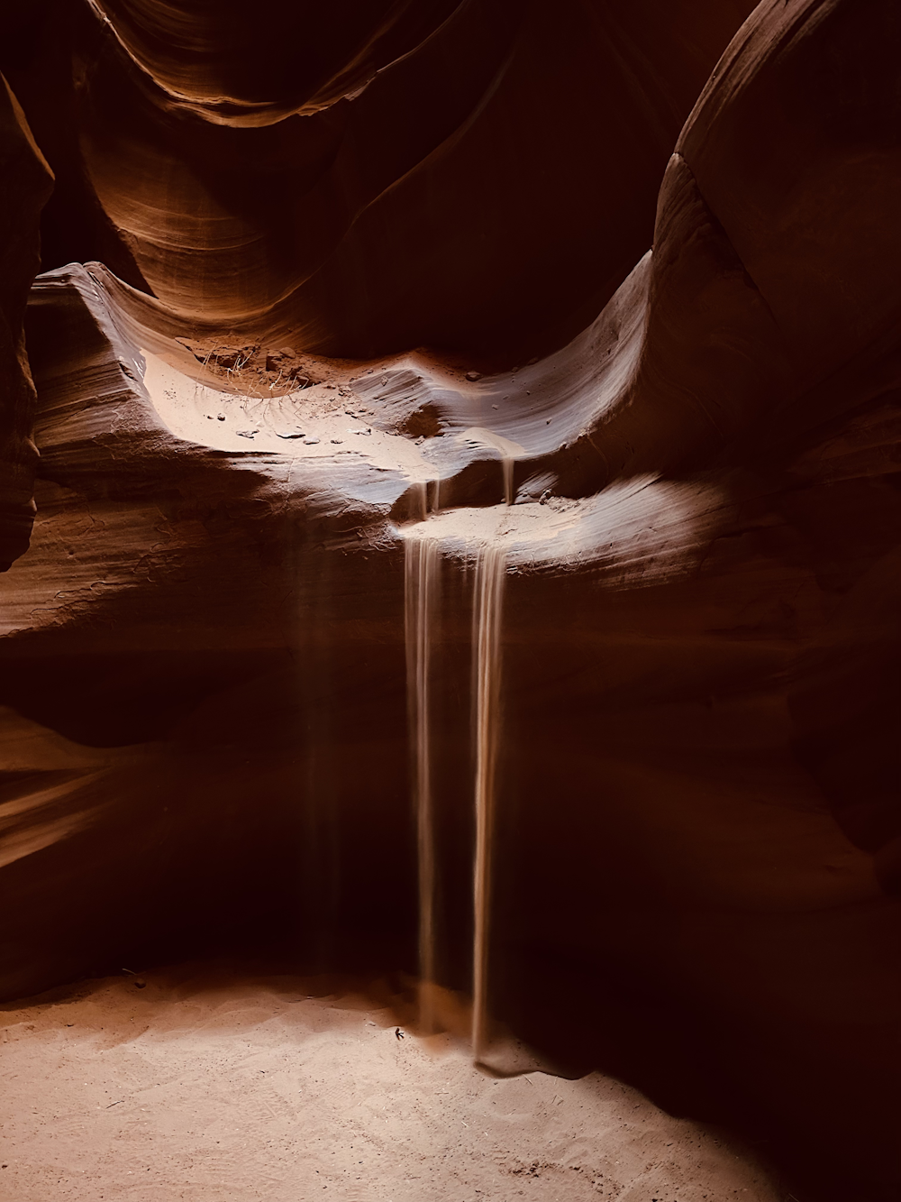a stream of water running through a slot in a canyon