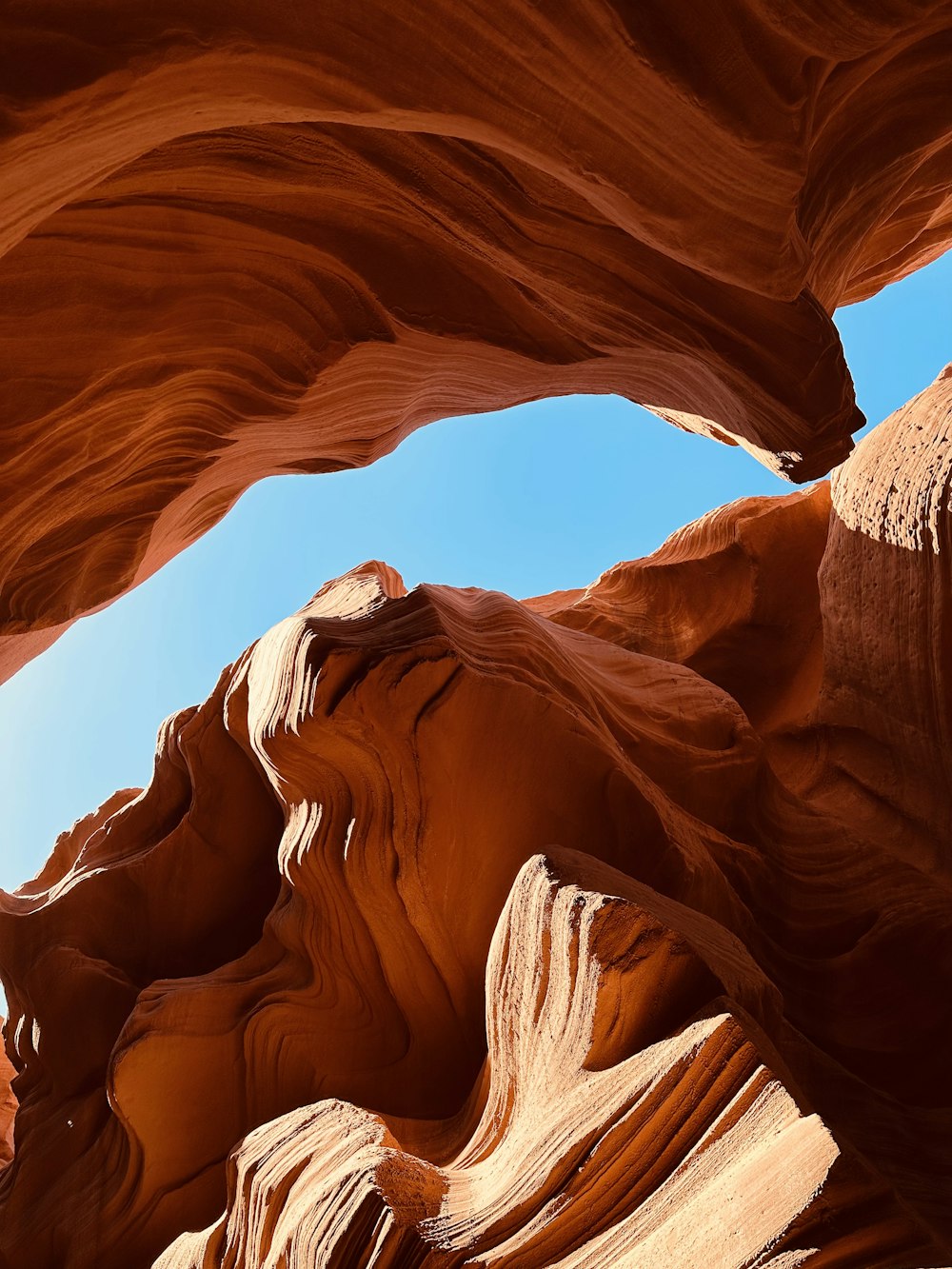 a large rock formation with a sky in the background