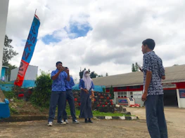 Industry partners shaking hands with SMKN 2 Berau representatives.
