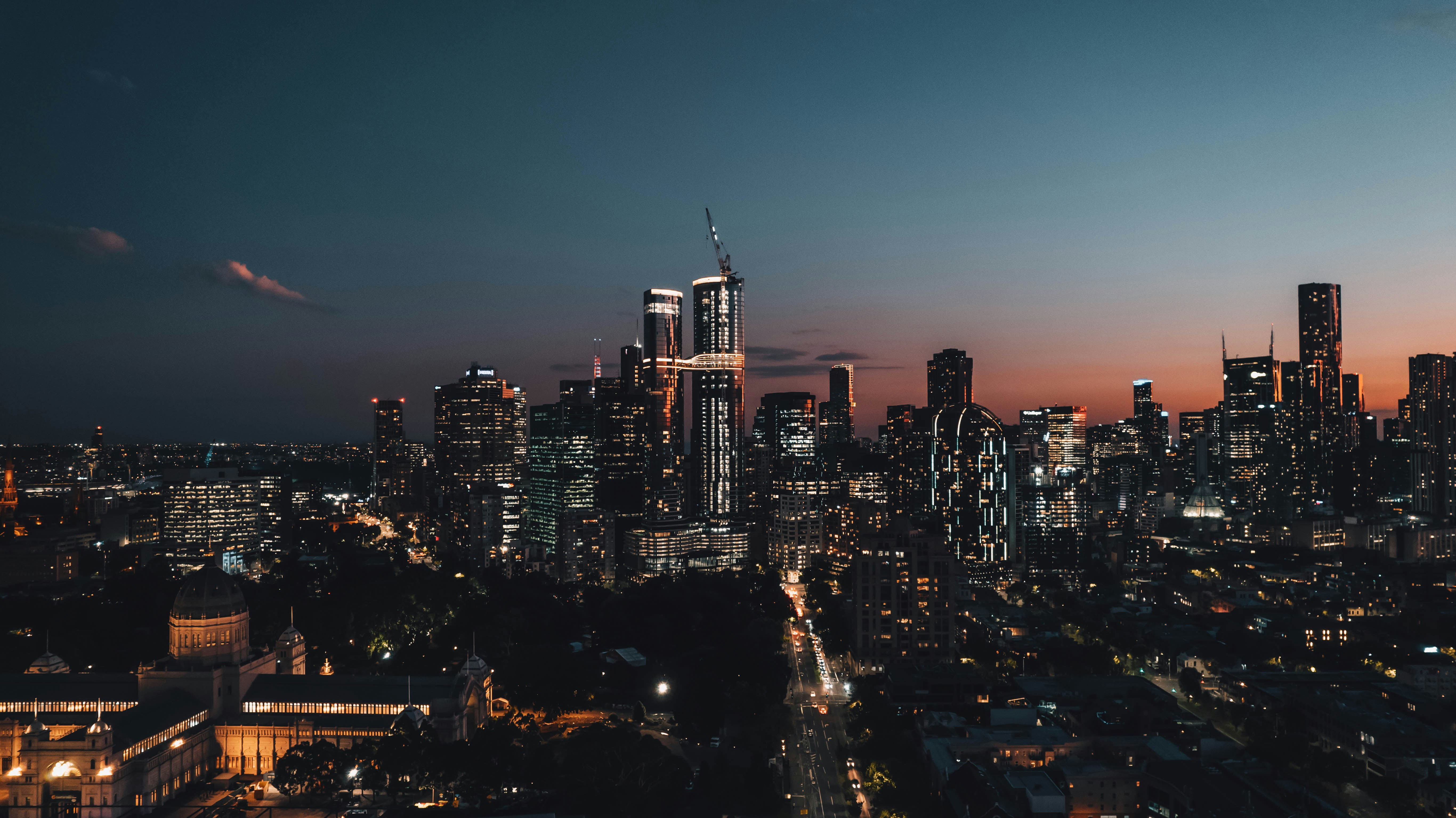 a view of a city at night from the top of a hill