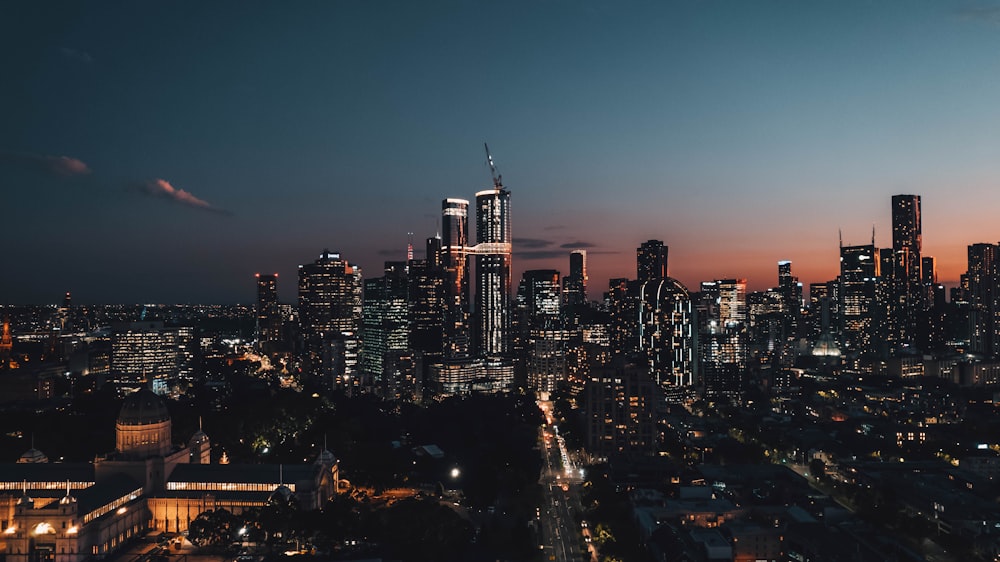 a view of a city at night from the top of a hill