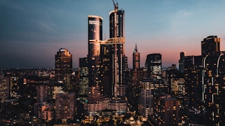 A city skyline at sunset, highlighting modern architecture.