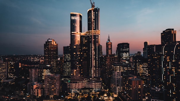 A city skyline at sunset, highlighting modern architecture.