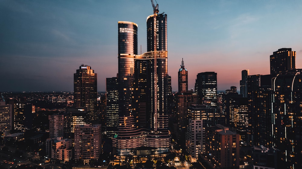 a view of a city at night from the top of a skyscraper