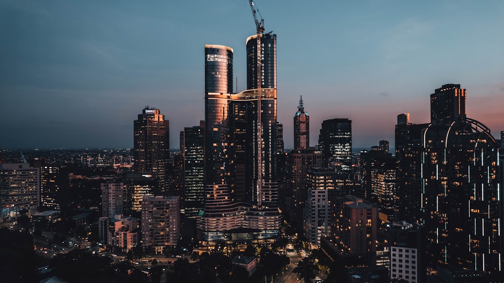 a view of a city at night from the top of a skyscraper