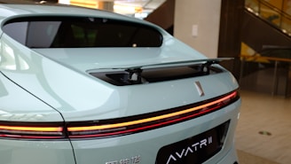 A sleek Aston Martin-inspired internet modem glowing with green and yellow lights