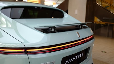 A sleek Aston Martin-inspired internet modem glowing with green and yellow lights