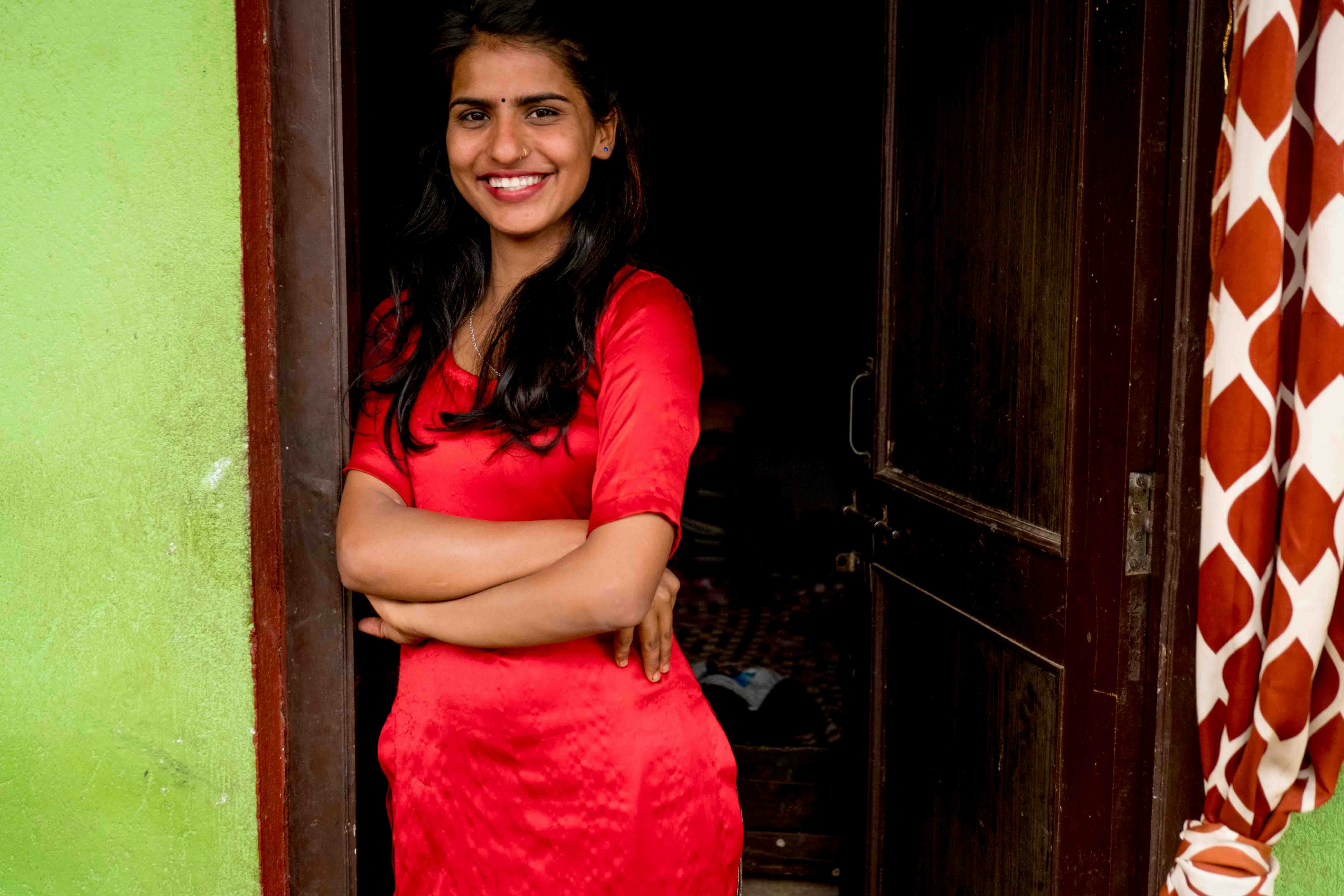 Woman in red dress standing in doorway