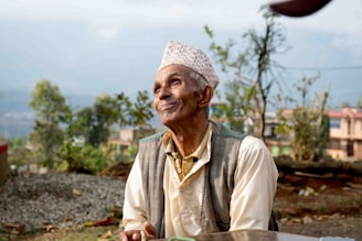 A wise Native American elder sharing stories during a peaceful outdoor gathering surrounded by nature.