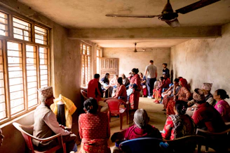 a group of people sitting in chairs in a room